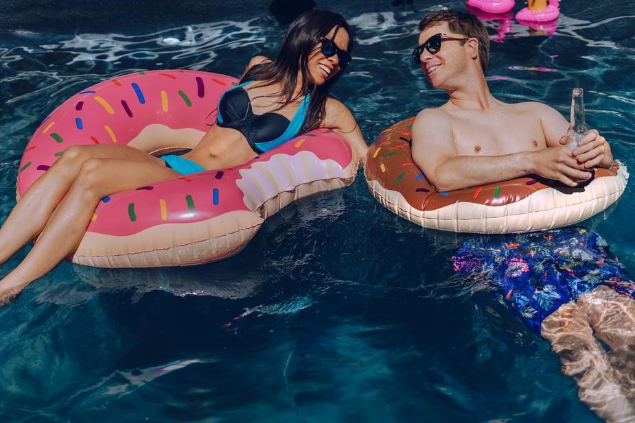 people relaxing in water on inflatable toys