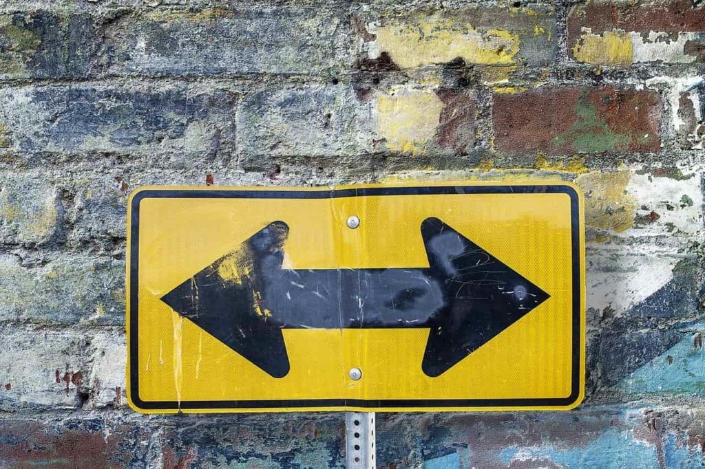 a sign with two arrows on it